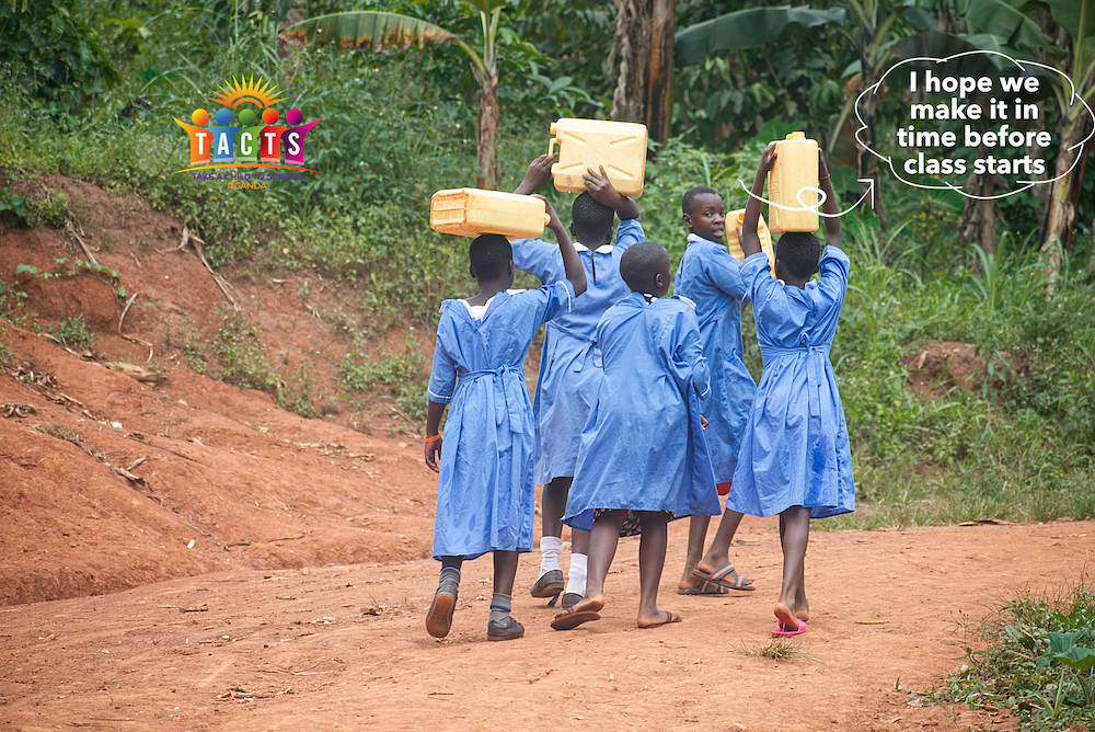 School girls carrying jerrycans